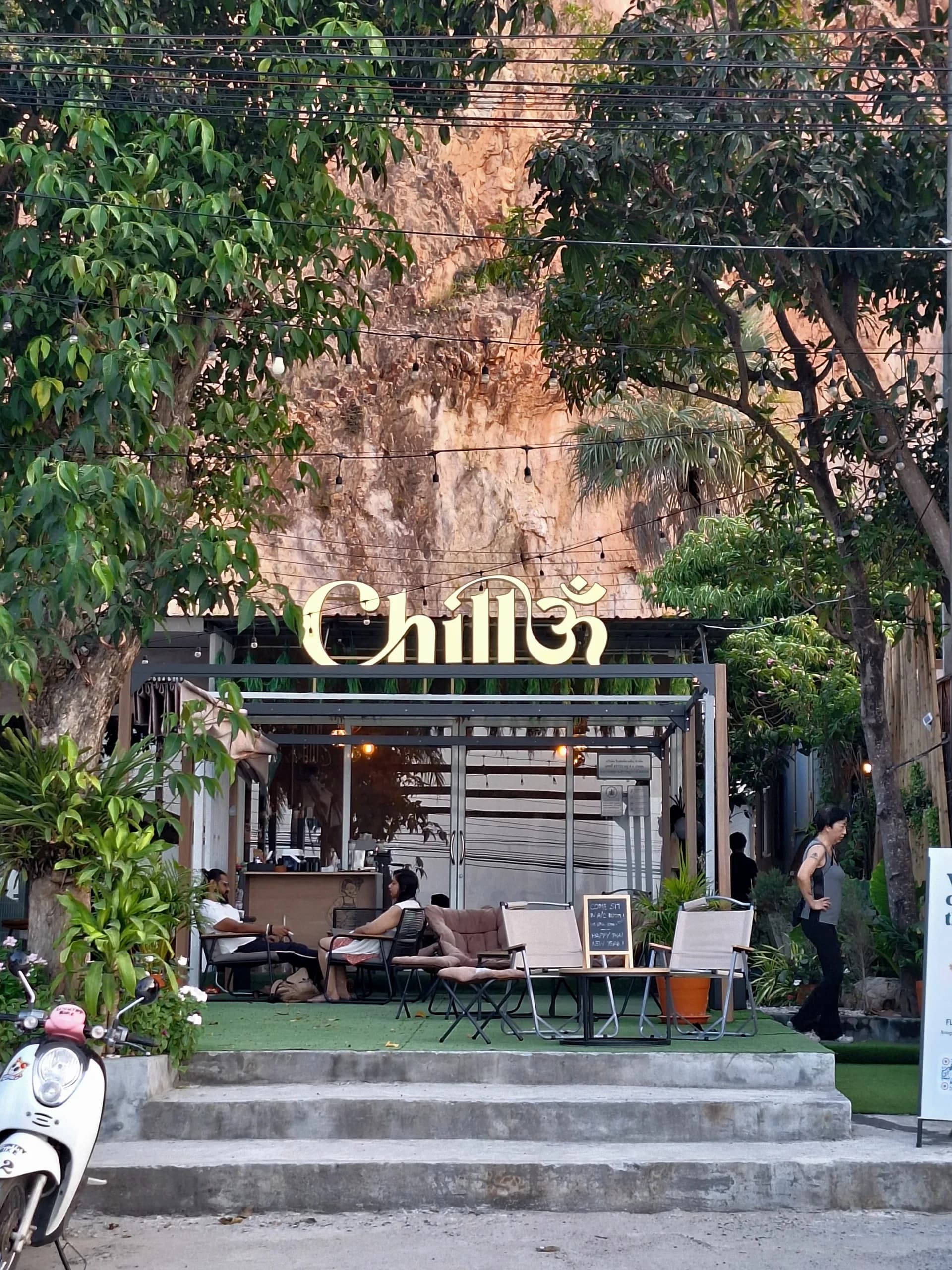 Chill Om front entrance with tropical plants and signage